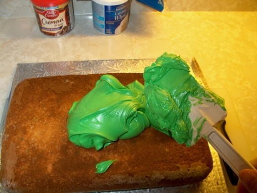 Applying the neon green icing sugar to base.