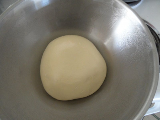 The dough  at rest in a greased bowl.