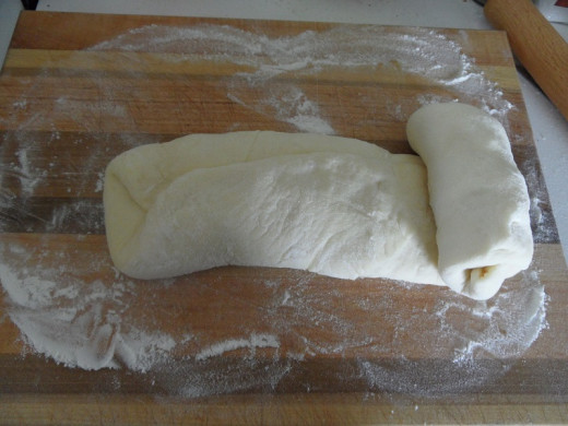 Rolling the dough up to develop the gluten.