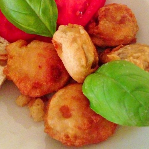 Serve the mushrooms in vodka batter with sliced tomato and basil