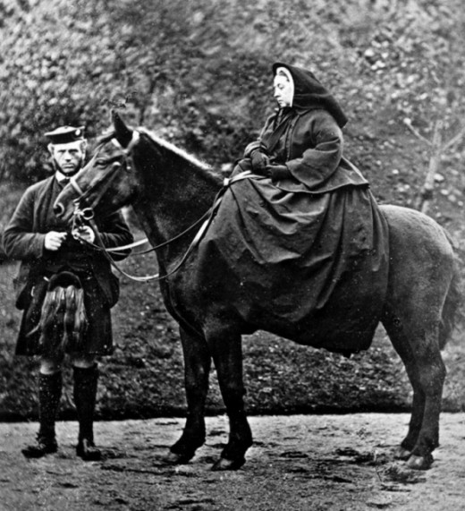 Queen Victoria on horseback. Seen with John Brown.