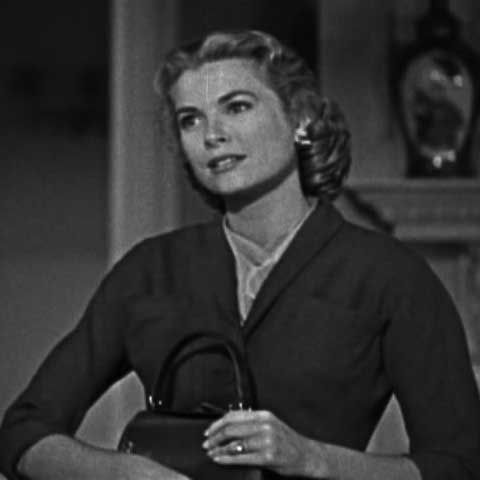 Scarves are a strong feature in this classic look. Here, her scarf acts as an accessory to a tailored jacket.