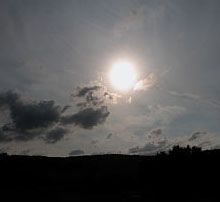 rays of the sun through clouds at dusk