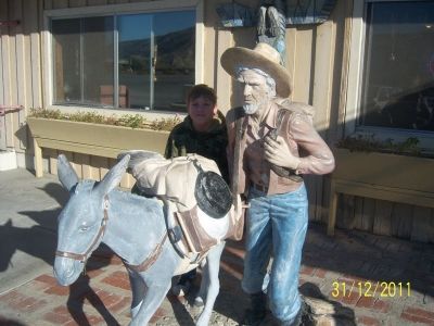 The Claude K. Bell miner and burro at the Wheel Inn