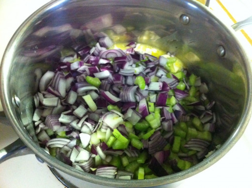 In a pot melt butter and add the onion and celery cooking until onion is translucent.