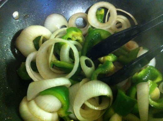 Add the green pepper and continue to stir-fry.