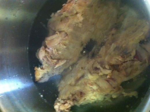 Cover the chicken carcasses with water.