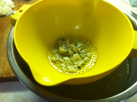Strain the soup broth from the pot into a large bowl.