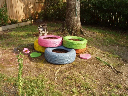 I spray painted and stacked tires with smaller ones on top and used old deli trays to close the bottom.  Filled with soil they keep my plants warm.
