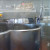 Foreground - the vat where the milk starts out. Right - the vat where the curds settle out. Very small, background - wheels of cheese being pressed. Foreground - the vat where the milk starts out. Right - the vat where the curds settle out. Very small, background - wheels of cheese being pressed.
