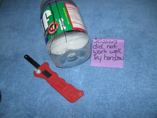 Scissors just would not cut it. I used a hand saw. Have an adult cut through the rim around the lid. The rest of the jar cuts easily with scissors.
