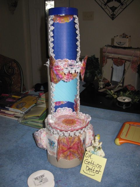 The silver trim around the door frames is silver crown ribbon. My tower leans a tad to the back. To prevent this in yours, cut off the rim from the backsides of the balconies before affixing the stack. (The part behind the notches).