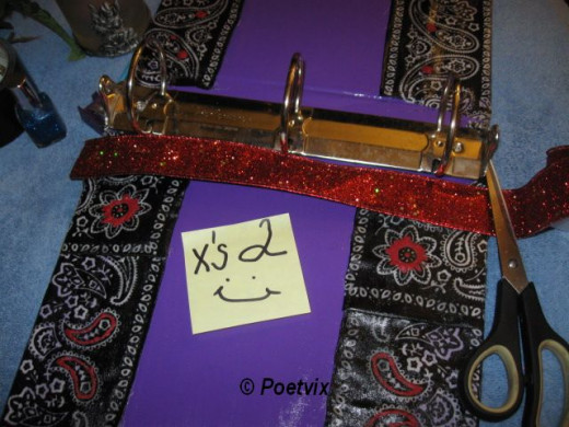 It is time for the trim. Cut the ribbon to line either side of the 3 ring post. You want about half an inch more than the length of the spine. Fold over the excess to create a good looking line. Glue it down being sure to press the edges under. 