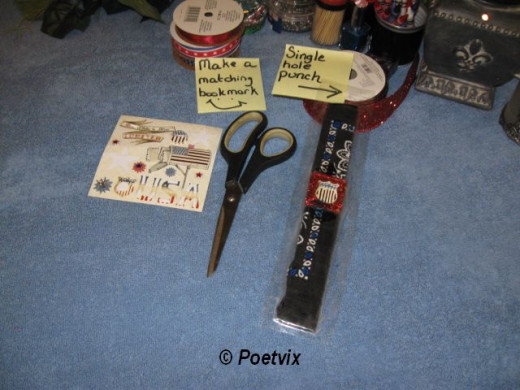 After wrestling what is too big to fit from the machine ;), trim the edges. Use a hole punch to make a hole at the top.