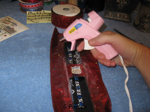 Cut two pieces of matching ribbon to the length of your laminated bookmark plus one inch. Glue down the front first to be sure you get the edges where you want them. Flip it over and glue down the back.