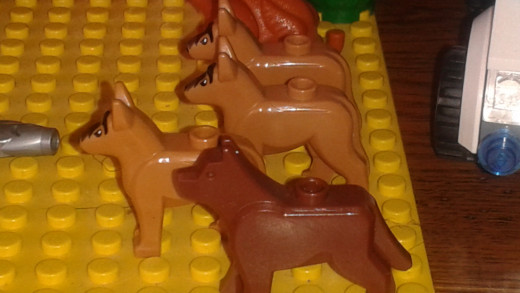4 Lego dogs.  3 German Shephards and 1 brown dog.