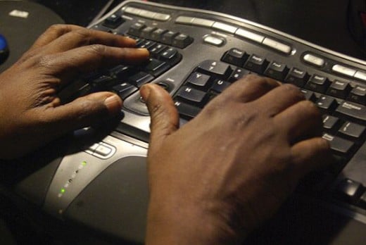 My husband's hands working on his computer.