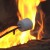 Roasting marshmallows over an open campfire.