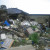 Damaged homes with piles of debris. Damaged homes with piles of debris.