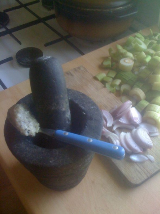 Crush the garlic, salt and pepper with a mortar and pestle. It will smell incredible.