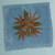 Coaster made with small leaves arranged in a circular pattern