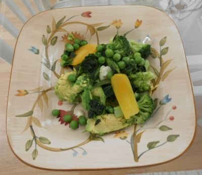 Mixture of steamed vegetables and avocado are ready for lunch
