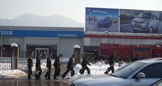 Soldiers marching with spades instead of guns during last year's worst winter in 100 years.