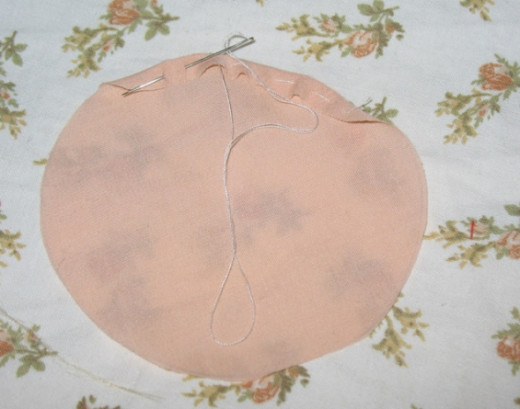 Fold the edge of the circle over and stitch in place. Fold the edge of the circle over and stitch in place.