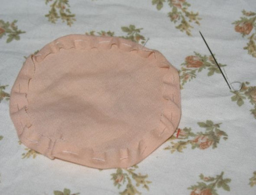 Carry on stitching the edge over until you've gone all the way around your circle. Carry on stitching the edge over until you've gone all the way around your circle.