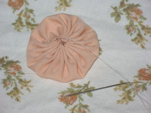 If you use big stitches you'll get a tight yoyo like I have in this image. If you use smaller stitches you'll get a wider opening at the centre of your yoyo. If you use big stitches you'll get a tight yoyo like I have in this image. If you use smaller stitches you'll get a wider opening at the centre of your yoyo.