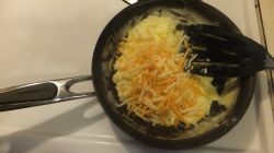 Making scrambled eggs with cheese