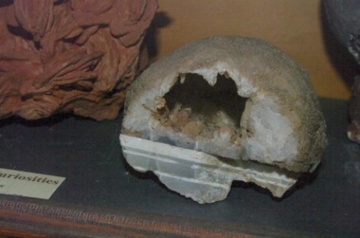 Geode, sliced in half so you can see the interior is hollow and lined with crystals.