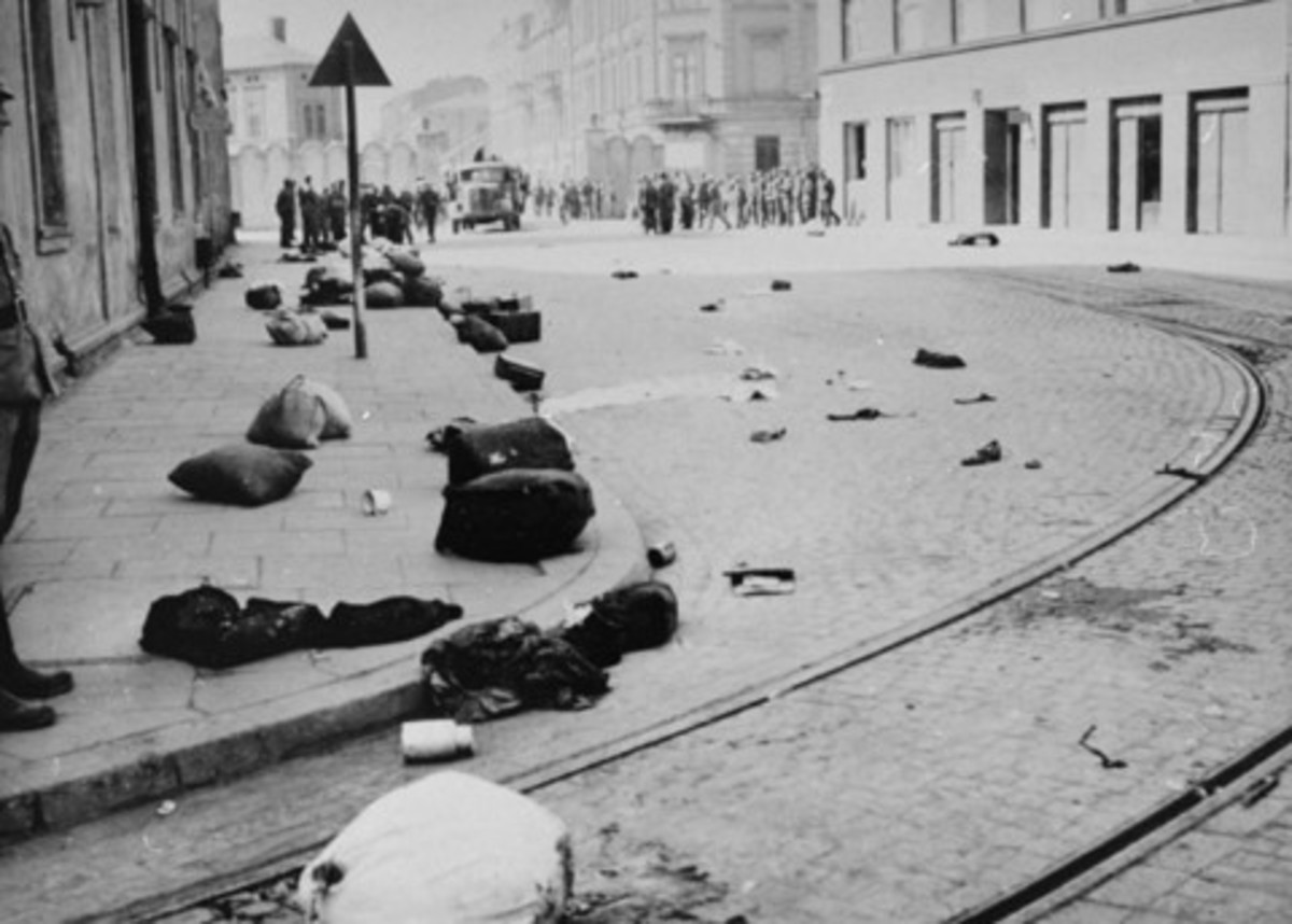 Major street in Krakow strewn with the bundles of deported Jews after the liquidation of the ghetto. [n]