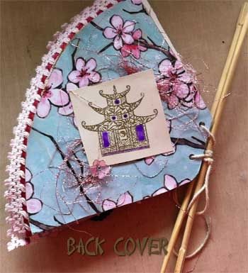 Back of the book. The pagoda is stamped and heat embossed and coloured with gel markers. I glued a little pink, metallic threat for decoration.