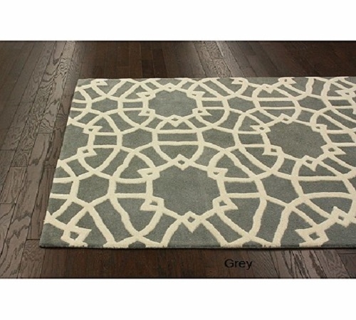 Art Deco-inspired wool area rug in a geometric fretwork design.  Much of Art Deco design makes use of geometric shapes and silhouettes for visual interest.  Pair it with a gray flannel sofa, a couple of sleek, cream side chairs, and a brushed steel c