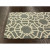 Art Deco-inspired wool area rug in a geometric fretwork design.  Much of Art Deco design makes use of geometric shapes and silhouettes for visual interest.  Pair it with a gray flannel sofa, a couple of sleek, cream side chairs, and a brushed steel c