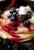 Blueberry pancakes with ice cream, raspberries and whipped topping.Photos by google images