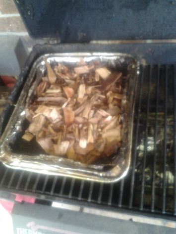 Once the coals are burning, place the tray of chips and chunks over them