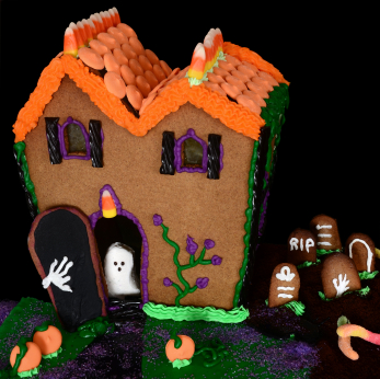 Here is a Halloween cake made out of gingerbread.   Looks like a Witch House to me!