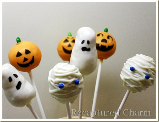 Don't be scared!  These Halloween cake pops are tasty and friendly as can be.  The mummy, the ghost and the pumpkin are from www.recapturedcharm.com