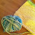 Cast on 24 stitches w/green yarn. Knit every row, changing colors after 4 rows. Knit until cloth measures 7". Knit four rows in green yarn. Cast off. Cast on 24 stitches w/green yarn. Knit every row, changing colors after 4 rows. Knit until cloth measures 7". Knit four rows in green yarn. Cast off.