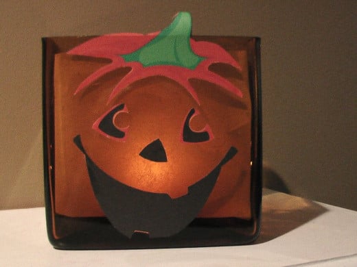 This was an easy (http://crafting.squidoo.com/very-easy-jackolantern-candle-craft-project) decoupage project I made one Halloween.